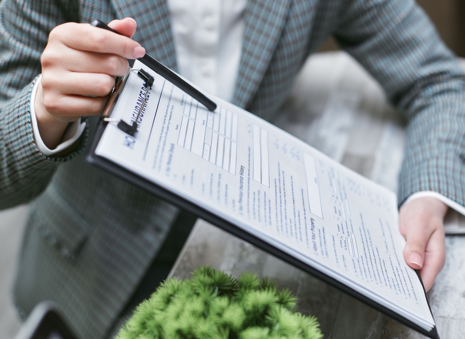 A blank insurance application with a pen