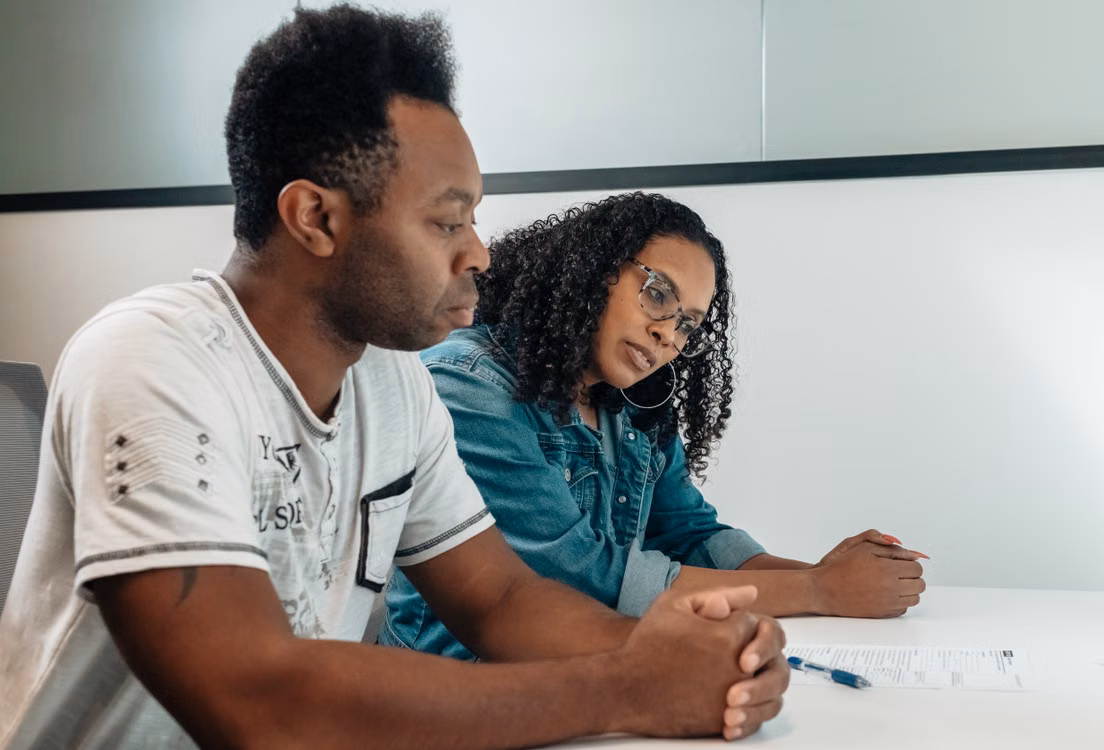 A couple reviewing coverage documents together at a table
