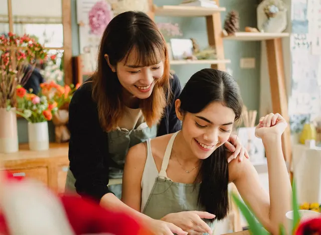 Two florists working together in a small shop